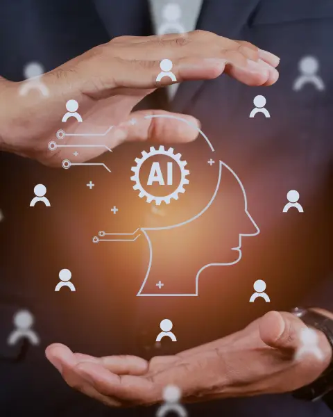 Two hands are cupped around a digital illustration of a human head with an AI symbol, surrounded by user icons, illustrating innovation and technology.